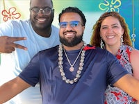 three people posing for a photo at an event