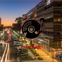 an image of a city at dusk with a building in the background